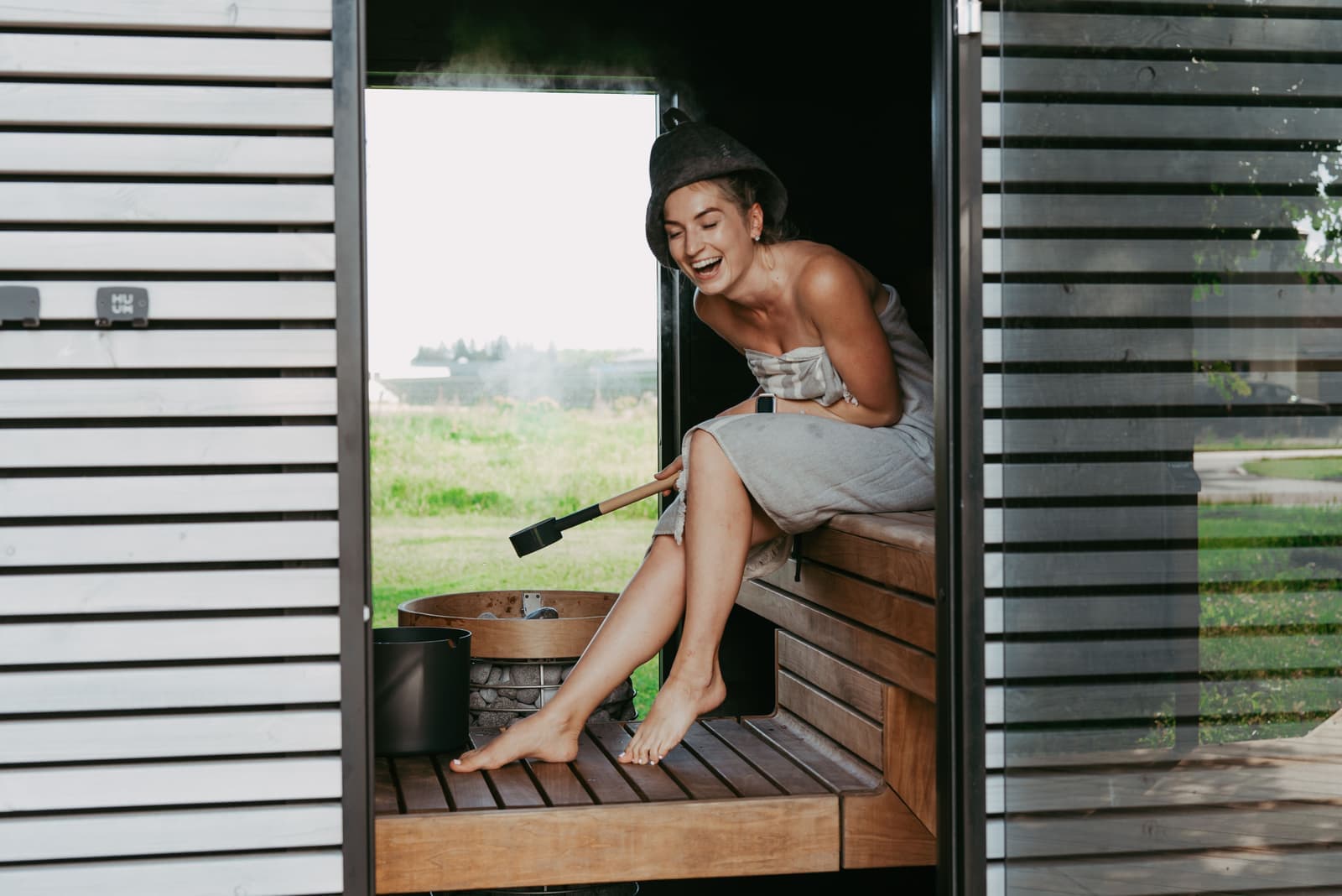 A sauna interior beside a cold water tub