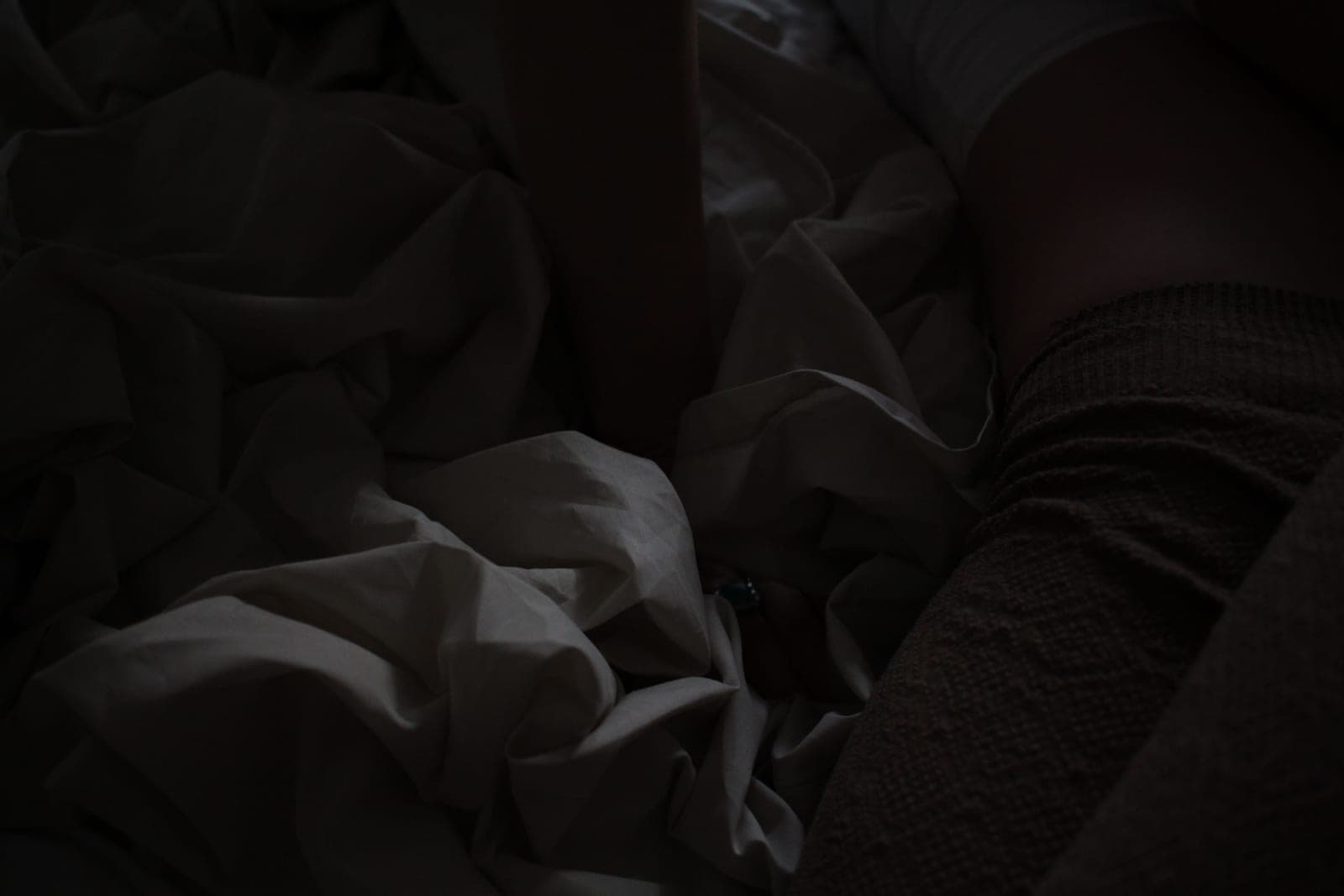 A heated blanket laid out across a bed in a plain domestic bedroom