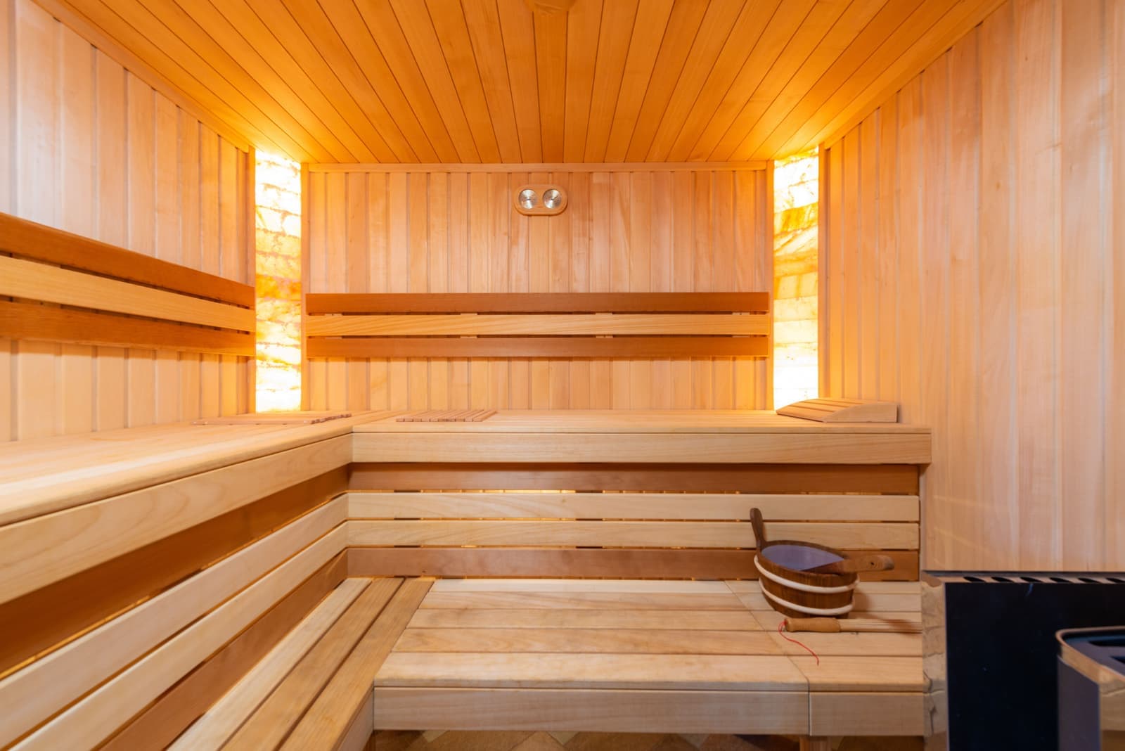 The wooden interior of a small home sauna room