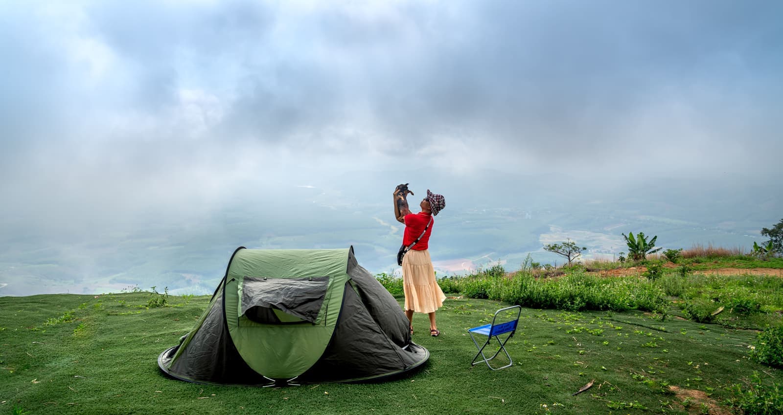 A person folding down a portable sauna tent