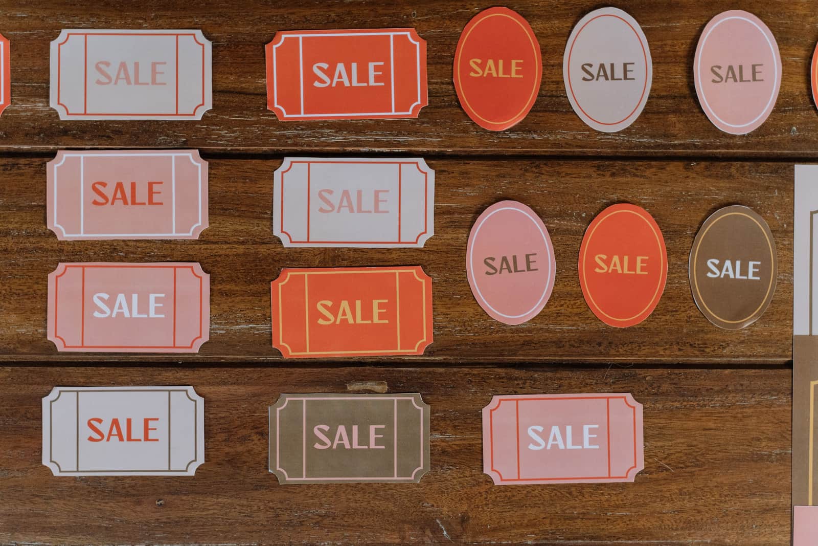 Retail price tags laid out on a wooden surface