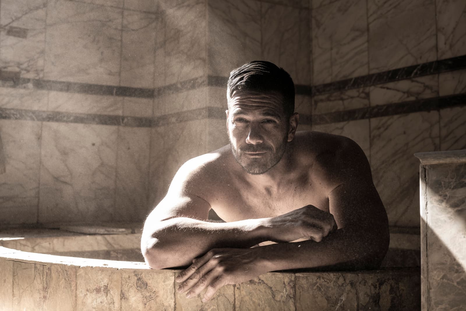 A man sitting inside a home sauna tent