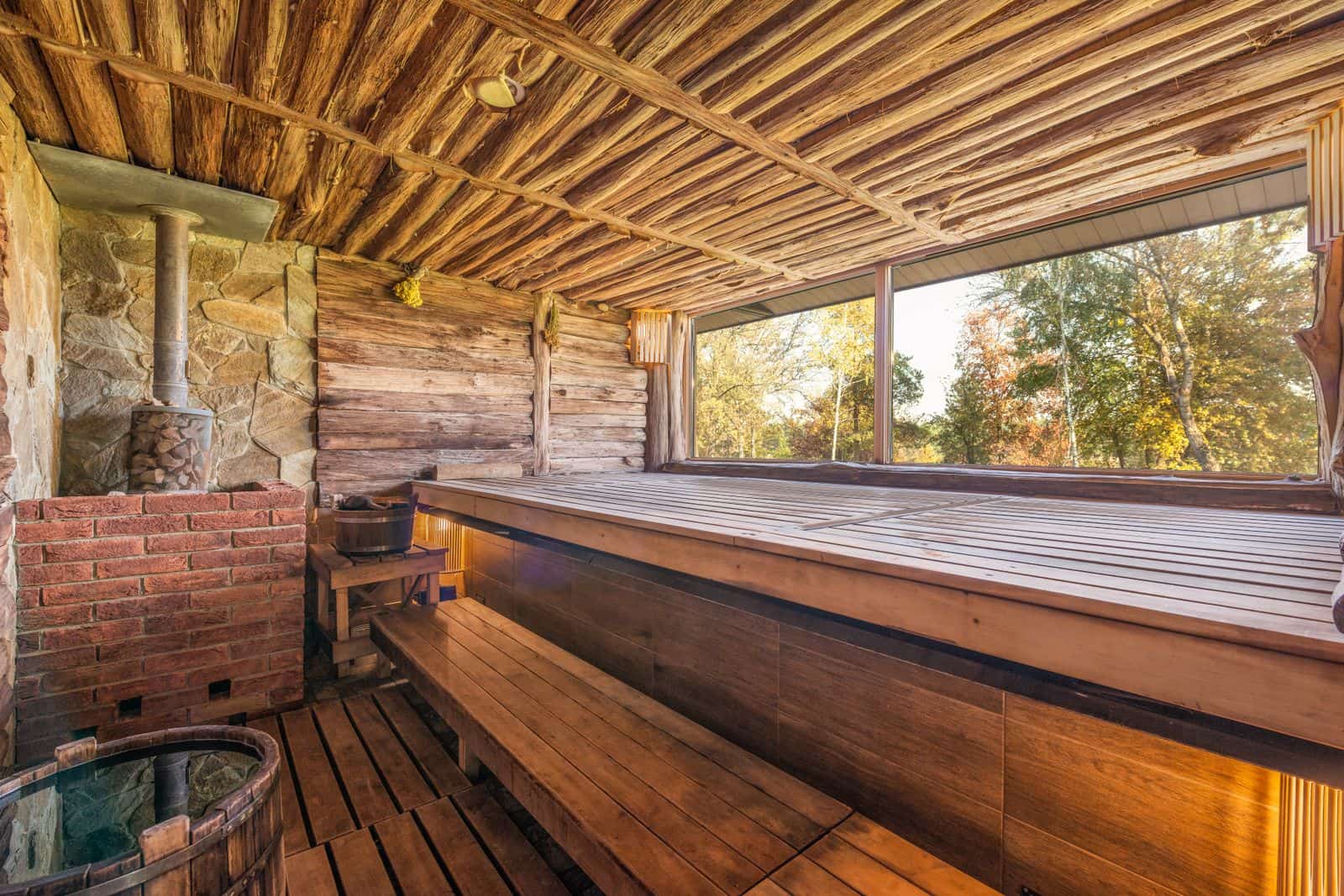 The wooden interior of a small sauna cabin