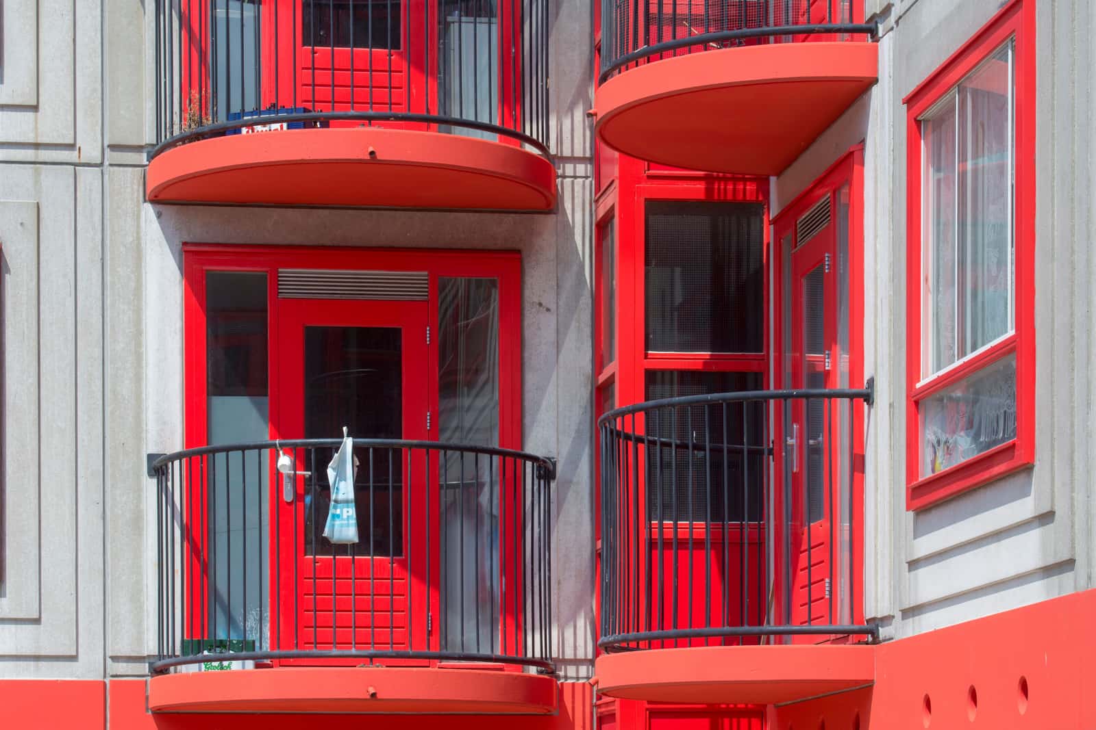 An apartment balcony with a hard floor and railing
